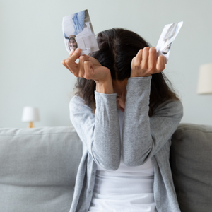 sad woman with torn up photo